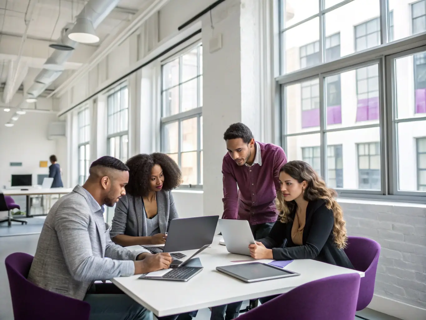 A diverse group of students collaborating on a digital marketing campaign in a modern, collaborative workspace, showcasing teamwork and creativity.